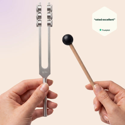 32 Hz tuning fork with a mallet held by hands against a beige background, with Trustpilot rating badge.