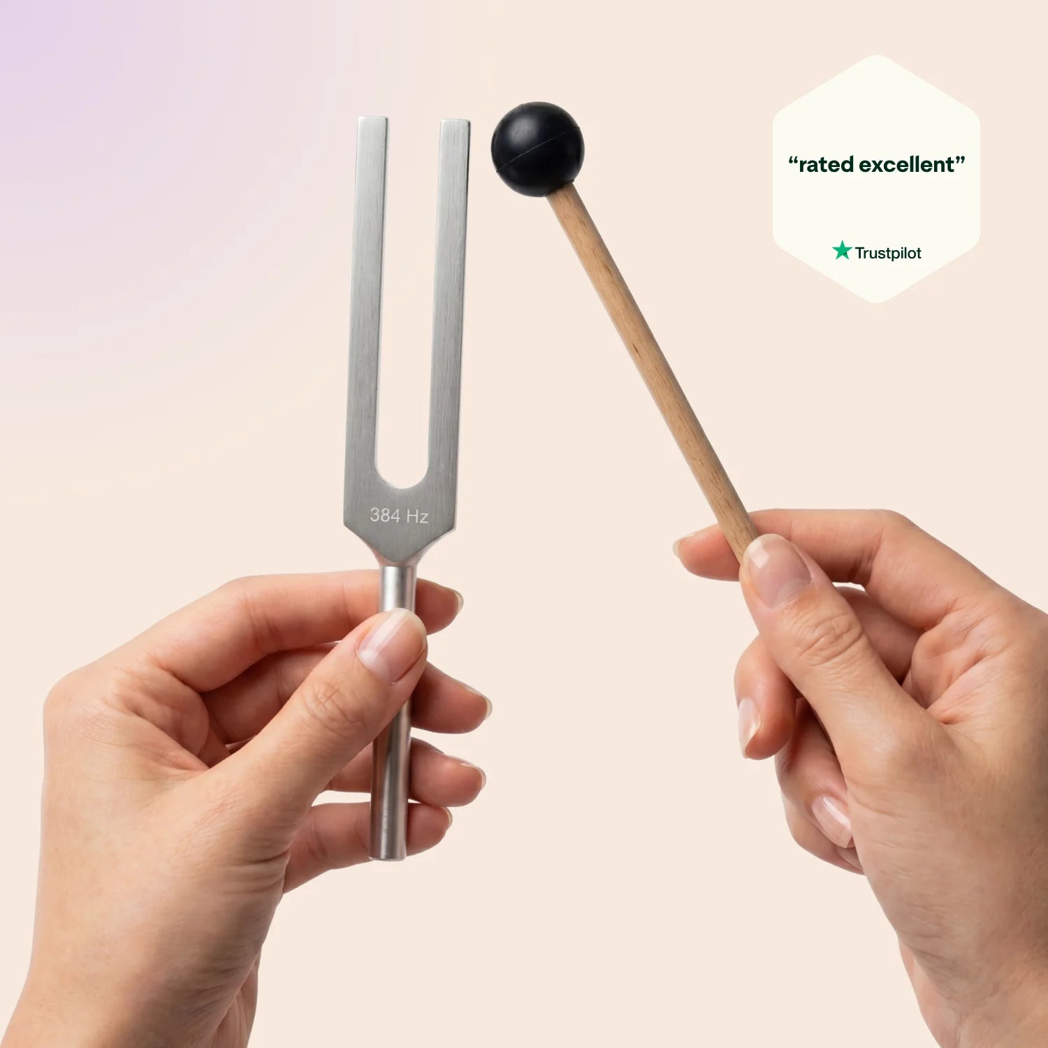 384 Hz tuning fork with a mallet held by hands against a beige background, Trustpilot rating visible.