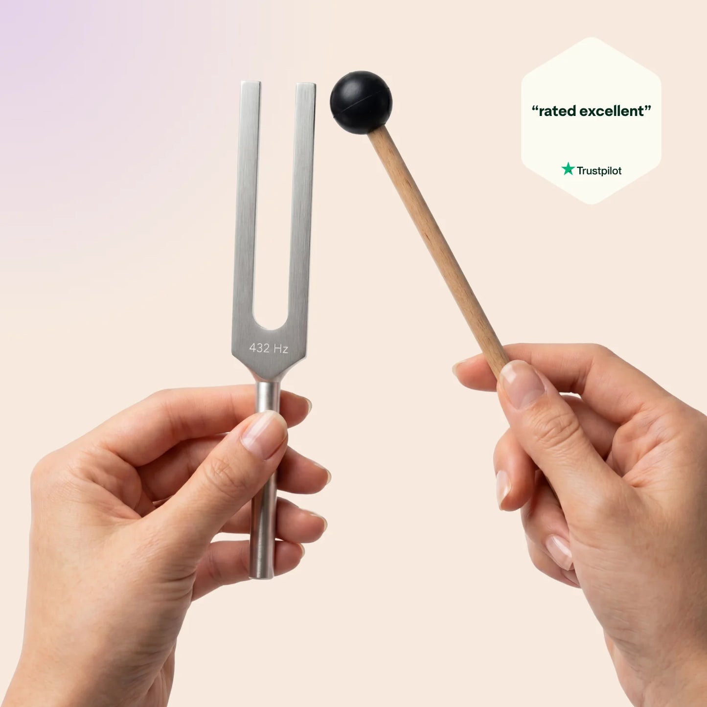 432 Hz tuning fork with a mallet held by hands against a light pink background, Trustpilot rating visible.