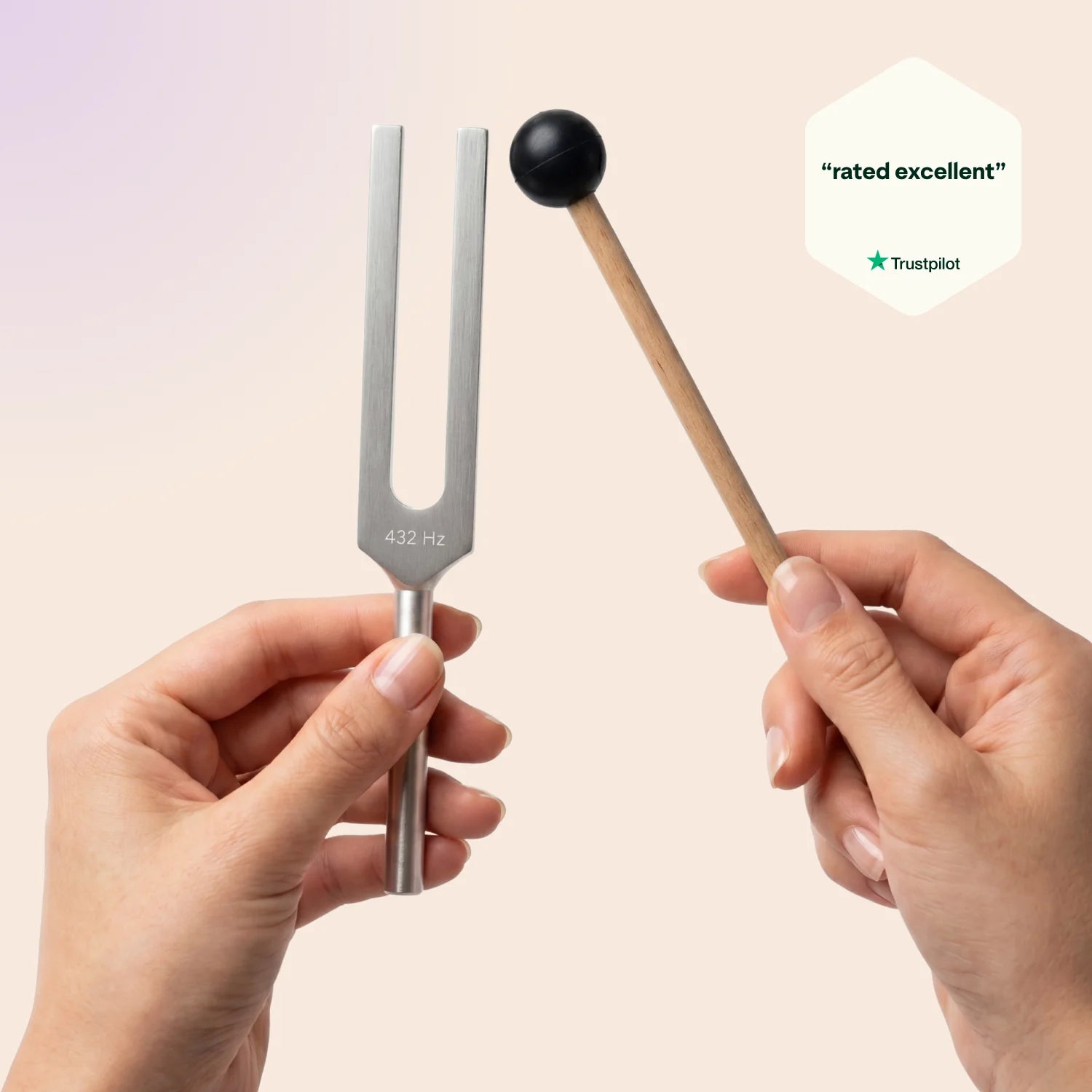 432 Hz tuning fork with a mallet held by hands against a light pink background, Trustpilot rating visible.