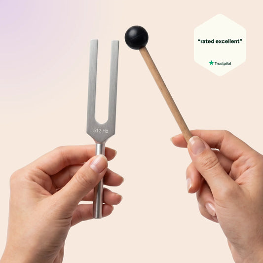 512 Hz tuning fork held by a hand with a neutral background, featuring Trustpilot rating.