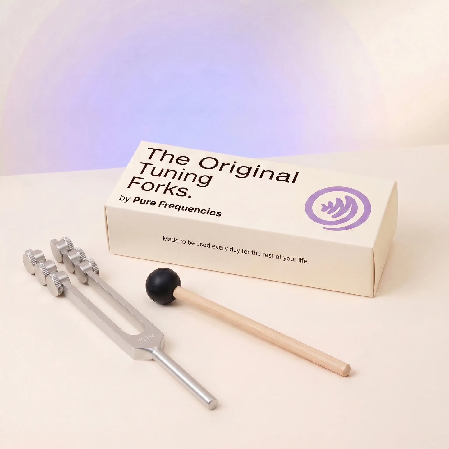 32 Hz tuning fork and packaging with 'The Original Tuning Forks by Pure Frequencies' on a light background