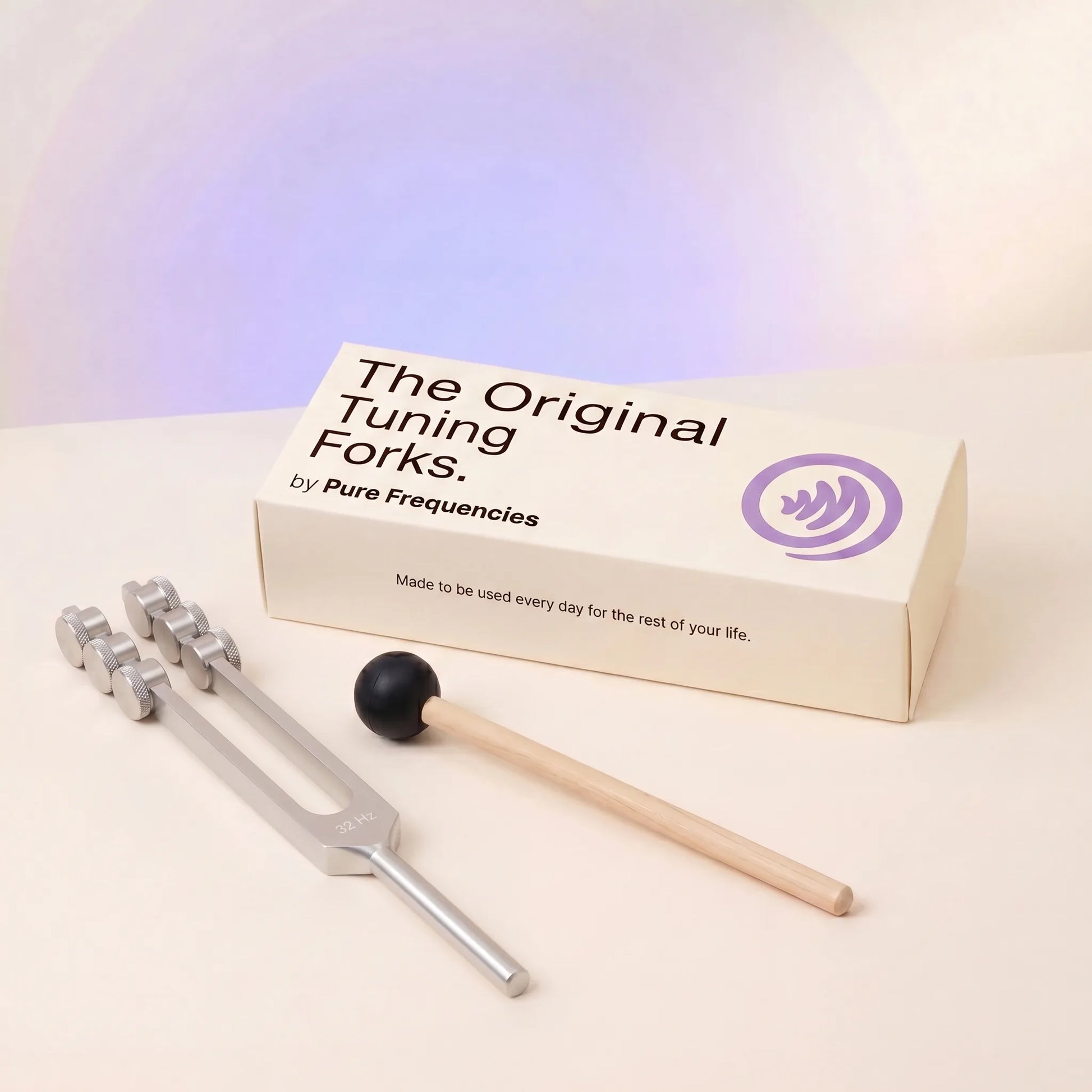 32 Hz tuning fork and packaging with 'The Original Tuning Forks by Pure Frequencies' on a light background
